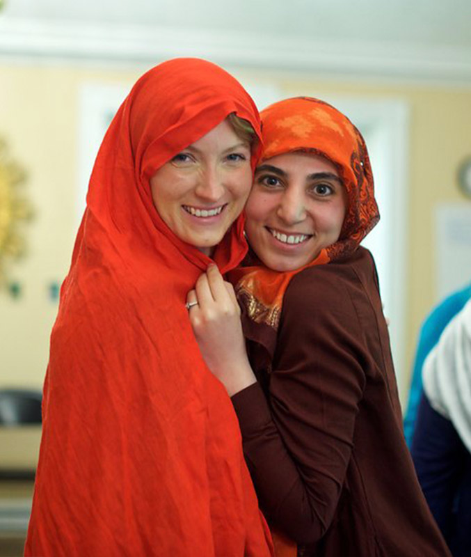 two Hartford International students in orange scarves