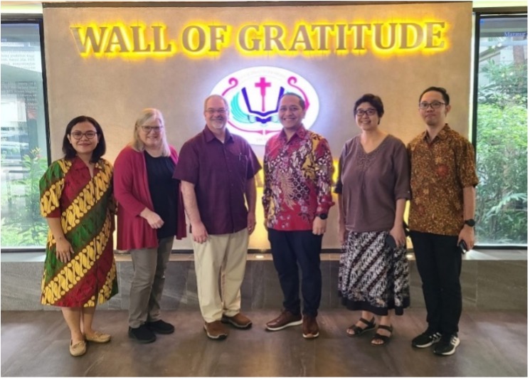 6 people in front of "Wall of Gratitude"