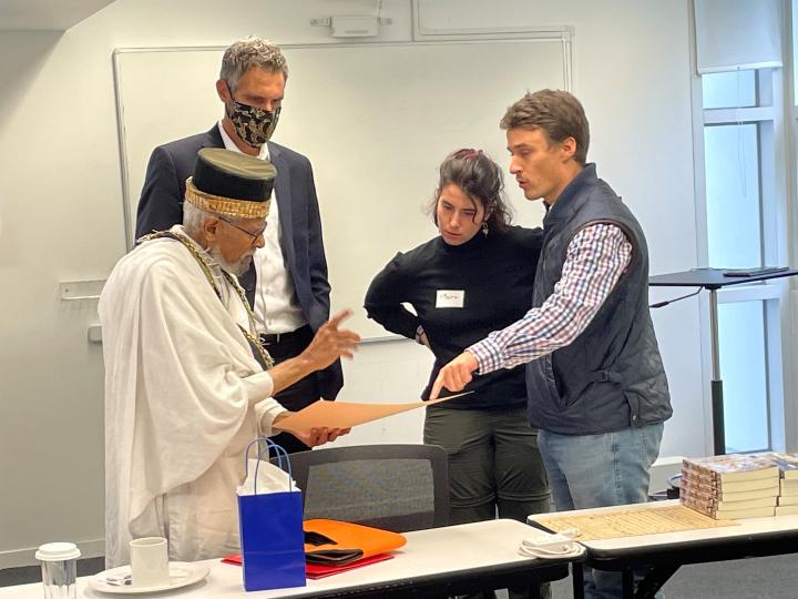 Dr. Ephraim Isaac with two students and President Lohr