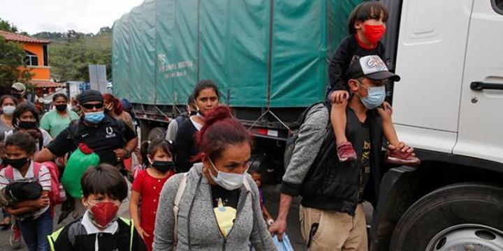 Migrants near a truck