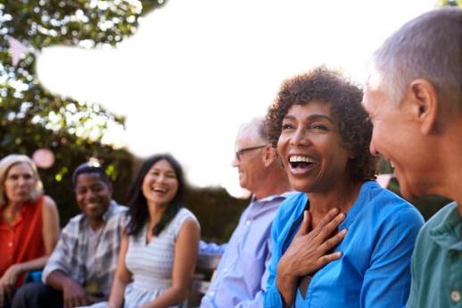 Woman with a big smile talking to others