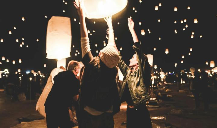 People launching lanterns