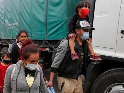 Migrants near a truck