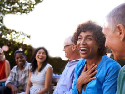 Woman with a big smile talking to others